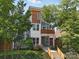 Attractive two-story home with a modern facade, balcony, and well-manicured front yard, blending contemporary design and inviting curb appeal at 708 Cross Trail Dr, Charlotte, NC 28204