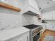 Well-equipped kitchen featuring stainless steel appliances, quartz countertops, marble backsplash, and modern cabinetry with wood accents at 708 Cross Trail Dr, Charlotte, NC 28204