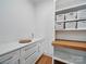 Well-organized pantry with ample counter space, cabinetry, open shelving, and storage baskets, providing efficient and accessible storage at 708 Cross Trail Dr, Charlotte, NC 28204