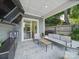 Outdoor patio features a comfortable seating area, ceiling fan, and television at 708 Cross Trail Dr, Charlotte, NC 28204