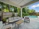 Covered patio with outdoor seating overlooking a private backyard pool and landscaping at 708 Cross Trail Dr, Charlotte, NC 28204