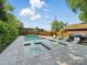 Backyard pool with a spa, surrounded by a stone patio and privacy landscaping at 708 Cross Trail Dr, Charlotte, NC 28204