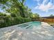 Backyard pool with a spa, surrounded by a stone patio and privacy landscaping at 708 Cross Trail Dr, Charlotte, NC 28204