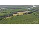Aerial shot displays the natural surrounding area, including wooded land, open land, and a river at 733 Killian Rd, Stanley, NC 28164