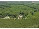 An aerial view displays the vast land surrounding a home and its outbuildings at 733 Killian Rd, Stanley, NC 28164