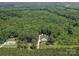A sprawling property is surrounded by lush greenery from an aerial vantage point at 733 Killian Rd, Stanley, NC 28164