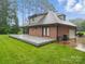 Spacious backyard features a brick home, a large deck, and well-maintained lawn with mature trees at 733 Killian Rd, Stanley, NC 28164