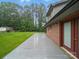 This backyard features a brick home, a large deck, and well-maintained lawn with mature trees at 733 Killian Rd, Stanley, NC 28164