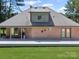 Brick home with backyard, large deck, exterior stars and circular window detail at 733 Killian Rd, Stanley, NC 28164