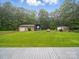 Backyard featuring green grass, a detached garage, and ample space for outdoor activities and landscaping at 733 Killian Rd, Stanley, NC 28164