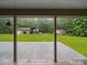 View from back porch of backyard with well-maintained lawn, detached garage and workshop at 733 Killian Rd, Stanley, NC 28164