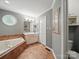 Bathroom features a jetted tub, vanity sink, and window at 733 Killian Rd, Stanley, NC 28164