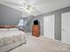Bedroom with a comfy bed, dresser, and closet space, bathed in soft light from the windows at 733 Killian Rd, Stanley, NC 28164