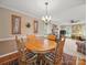 Bright dining room featuring a wooden table and chairs next to the inviting living room at 733 Killian Rd, Stanley, NC 28164