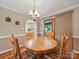 Cozy dining room featuring a wooden table and chairs with views through to the kitchen at 733 Killian Rd, Stanley, NC 28164