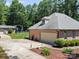 View of the brick home with a detached garage and long driveway with lots of privacy at 733 Killian Rd, Stanley, NC 28164