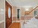 Foyer featuring hardwood floors, staircase, and an elegant wooden door at 733 Killian Rd, Stanley, NC 28164