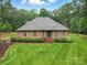 Beautiful brick home featuring manicured landscaping, an inviting entrance, and a cozy front porch at 733 Killian Rd, Stanley, NC 28164