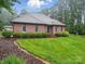 Charming brick home showcases beautiful landscaping, trimmed bushes, and inviting front entrance at 733 Killian Rd, Stanley, NC 28164