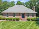 Charming brick home featuring a well-manicured front lawn and mature landscaping at 733 Killian Rd, Stanley, NC 28164