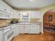 Well-lit kitchen with archway view of dining room area at 733 Killian Rd, Stanley, NC 28164