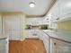 Bright kitchen features white cabinets, granite countertops, and wood floors at 733 Killian Rd, Stanley, NC 28164