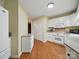 Well-lit kitchen features white cabinetry, granite countertops, hardwood floors, and modern appliances at 733 Killian Rd, Stanley, NC 28164