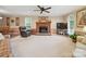 Spacious living room with fireplace, plush carpeting, a ceiling fan, and large window at 733 Killian Rd, Stanley, NC 28164