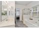 Bathroom featuring a tub, separate glass shower, single sink vanity, and wood-look flooring at 7704 Ninth Fairway Ln, Mint Hill, NC 28227