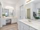 Well-lit bathroom with double vanities, ample counter space, decorative mirrors, and updated fixtures at 7704 Ninth Fairway Ln, Mint Hill, NC 28227