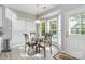 Inviting breakfast nook with glass table, surrounded by windows offering a view to the pool and yard at 7704 Ninth Fairway Ln, Mint Hill, NC 28227