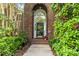 Close up of the front door with brick surround and beautiful landscaping at 7704 Ninth Fairway Ln, Mint Hill, NC 28227