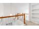 Upstairs hallway features wood and white banister and overlooks the main floor at 7704 Ninth Fairway Ln, Mint Hill, NC 28227