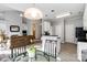 Open-concept living room with a view to the kitchen and an adjacent dining area at 7704 Ninth Fairway Ln, Mint Hill, NC 28227