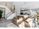 Open-concept living room with stairs and view of kitchen at 7704 Ninth Fairway Ln, Mint Hill, NC 28227