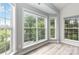 Bright sitting area featuring large windows overlooking the landscaped yard with a pool at 7704 Ninth Fairway Ln, Mint Hill, NC 28227