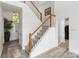 Bright foyer featuring a staircase with carpeted steps, white risers, and wooden handrail at 7704 Ninth Fairway Ln, Mint Hill, NC 28227