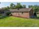 A well-manicured backyard with a swing set and plenty of green space, ideal for outdoor activities at 810 Surry Dr, Shelby, NC 28152
