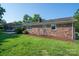 A well-maintained backyard featuring a swing, a bird bath and a lush green lawn at 810 Surry Dr, Shelby, NC 28152