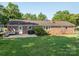 A spacious backyard features a well-maintained lawn, patio area, and mature trees, perfect for outdoor living at 810 Surry Dr, Shelby, NC 28152