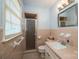 Classic bathroom with pink tiled walls, a glass-enclosed shower, and a vanity with sink, exuding vintage charm at 810 Surry Dr, Shelby, NC 28152