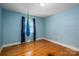 Relaxing bedroom with hardwood floors, light blue walls, natural light, and a calming swing chair feature at 810 Surry Dr, Shelby, NC 28152