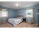 Comfortable bedroom featuring neutral carpet, natural light from two windows, and soothing blue walls at 810 Surry Dr, Shelby, NC 28152