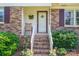 Inviting front porch with a charming decorative front door and brick steps at 810 Surry Dr, Shelby, NC 28152