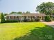 Charming brick home with a well-maintained lawn and mature landscaping at 810 Surry Dr, Shelby, NC 28152