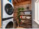 Practical laundry room featuring a modern washer and dryer setup and wooden shelving at 810 Surry Dr, Shelby, NC 28152