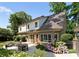 Spacious backyard featuring a patio with dining and lounge areas, surrounded by beautiful gardens at 901 Hartford Ave, Charlotte, NC 28209