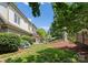Lush backyard with a stone patio, outdoor seating, and a well-manicured lawn and garden at 901 Hartford Ave, Charlotte, NC 28209