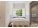 Bright bathroom with a large soaking tub under window, and a glass-enclosed shower at 901 Hartford Ave, Charlotte, NC 28209