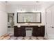 Well-lit bathroom featuring dual sinks, a large framed mirror, and vanity seating at 901 Hartford Ave, Charlotte, NC 28209